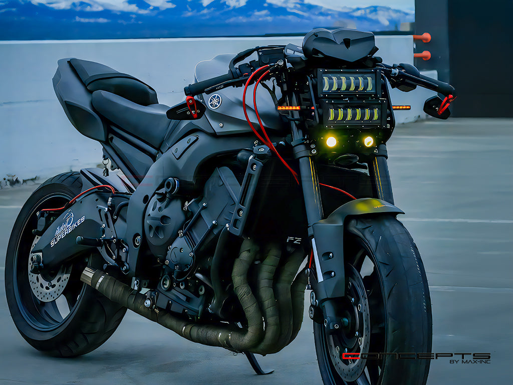 A sleek black Yamaha FZ motorcycle with custom vertical LED headlights, red accents, and 'SUPERBIKES' branding on the engine cover, parked in front of a blue sky and white wall backdrop